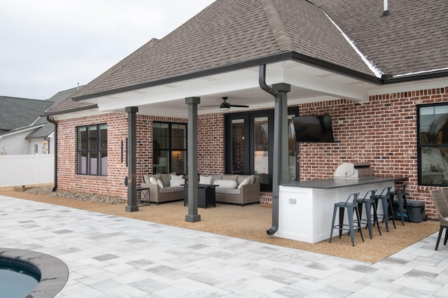 view of patio / terrace with outdoor lounge area, a bar, and exterior kitchen