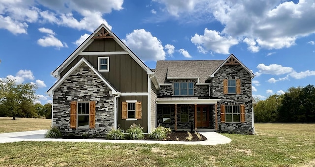 view of front of home featuring covered porch and a front yard