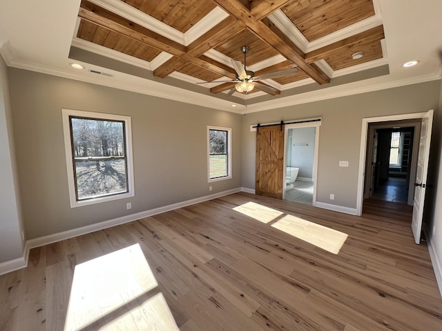 unfurnished bedroom with a barn door, ornamental molding, wood ceiling, and coffered ceiling