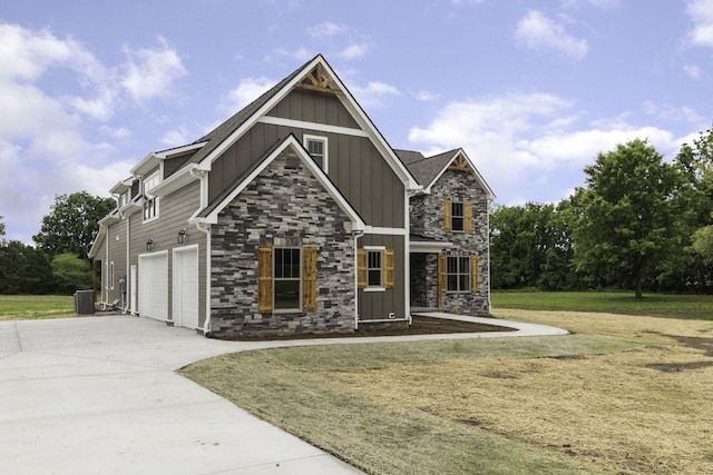 craftsman house with central AC unit, a front yard, and a garage