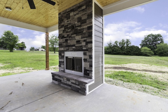 view of patio featuring ceiling fan and an outdoor stone fireplace