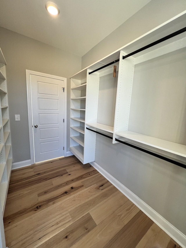 spacious closet with light hardwood / wood-style flooring