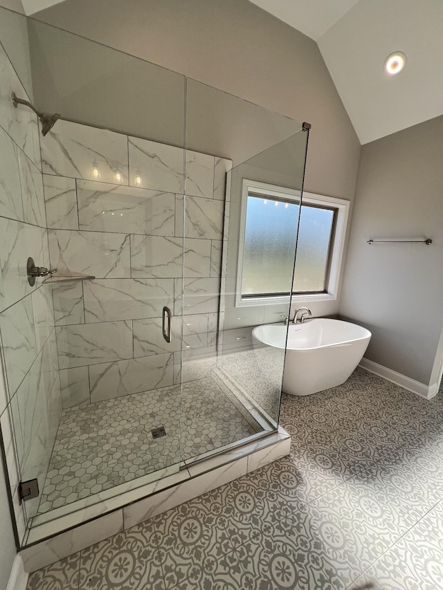 bathroom with tile patterned floors, independent shower and bath, and lofted ceiling