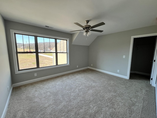 interior space featuring ceiling fan, light carpet, and vaulted ceiling