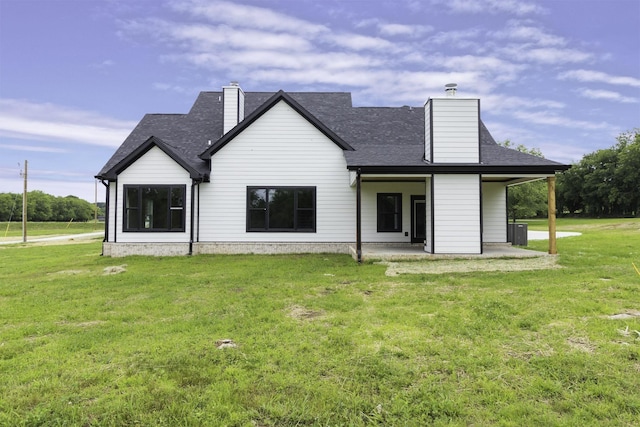 back of house featuring a patio, central AC unit, and a lawn