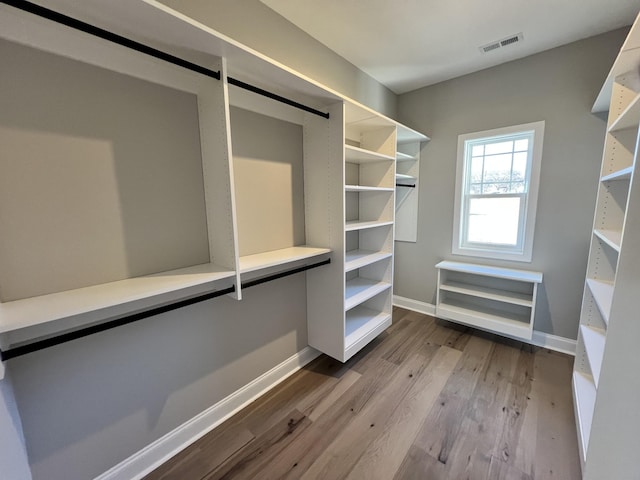 walk in closet featuring hardwood / wood-style floors