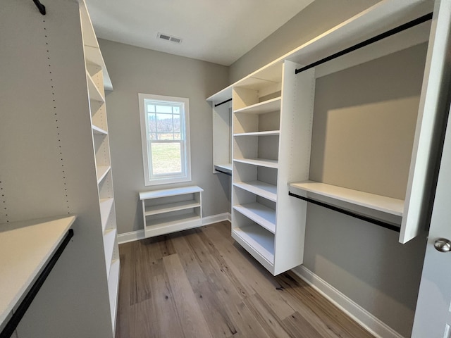 spacious closet with light hardwood / wood-style floors