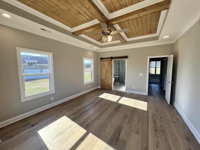 unfurnished bedroom featuring a barn door, crown molding, wooden ceiling, and dark hardwood / wood-style floors