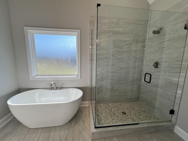 bathroom featuring shower with separate bathtub