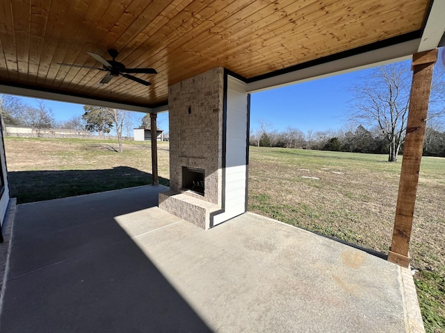 view of patio / terrace with an outdoor brick fireplace and ceiling fan