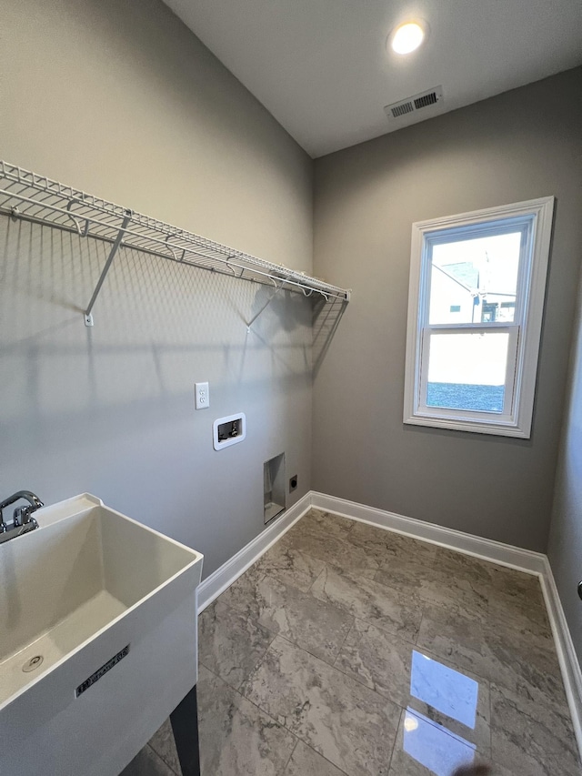 laundry area featuring hookup for an electric dryer, hookup for a washing machine, and sink