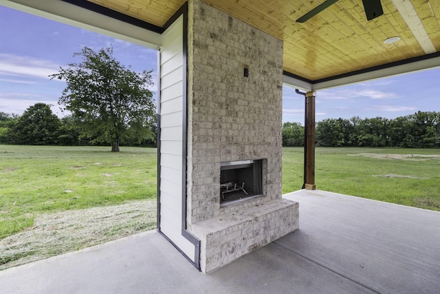 view of patio / terrace with an outdoor brick fireplace and ceiling fan