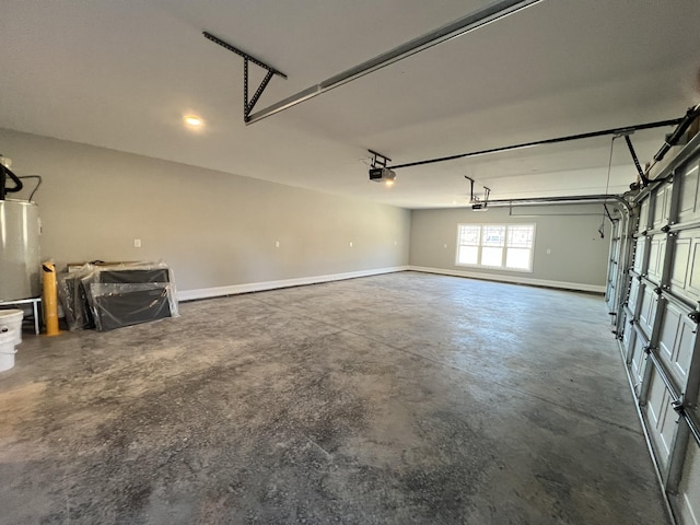 garage with a garage door opener and water heater