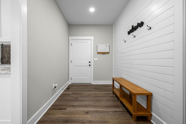 doorway to outside with wooden walls and dark hardwood / wood-style flooring