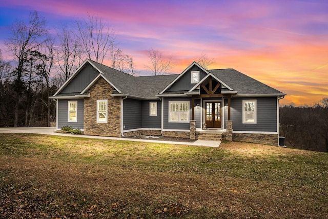 craftsman inspired home with a lawn and french doors