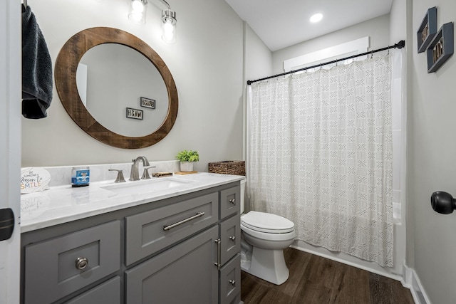 bathroom featuring vanity, toilet, and wood-type flooring