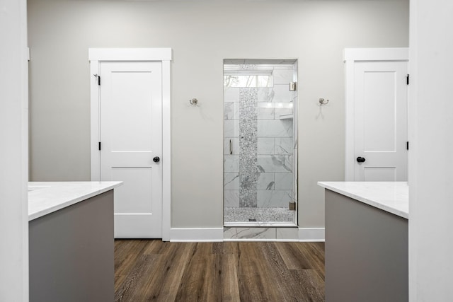 bathroom featuring vanity, a shower with shower door, and hardwood / wood-style flooring