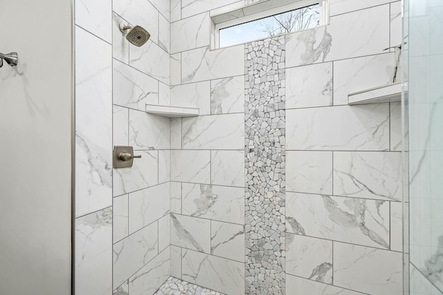 bathroom featuring a tile shower