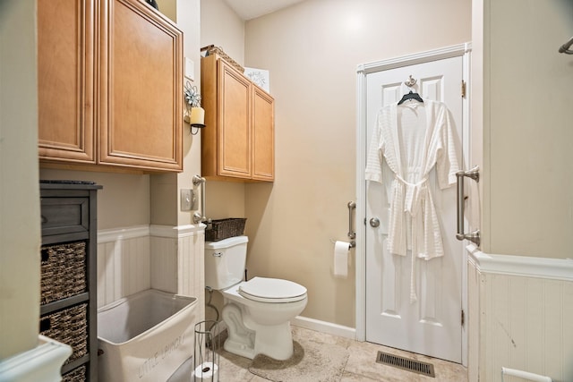 bathroom featuring tile patterned floors and toilet