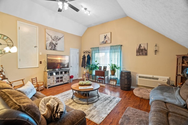 living room with ceiling fan, a wall mounted air conditioner, hardwood / wood-style floors, a textured ceiling, and vaulted ceiling