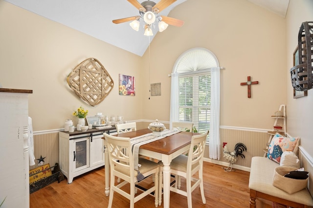 dining room with ceiling fan, light hardwood / wood-style flooring, and lofted ceiling