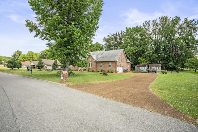 view of front of house featuring a front lawn and a garage