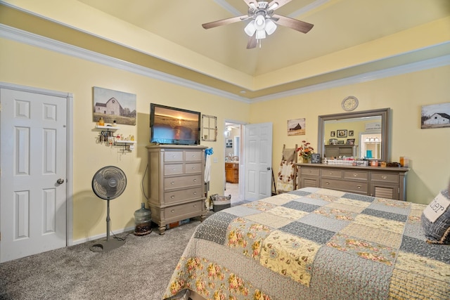 carpeted bedroom featuring a tray ceiling, ceiling fan, and crown molding