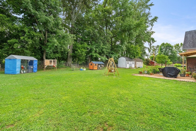 view of yard featuring a shed, a trampoline, and a patio