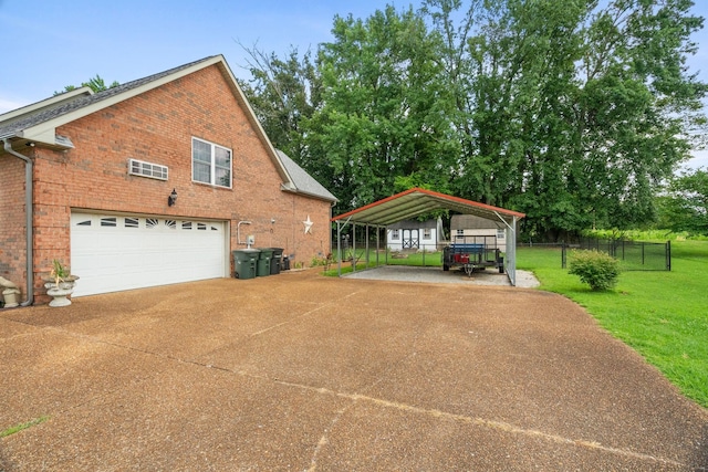 view of side of home with a carport, a garage, and a yard