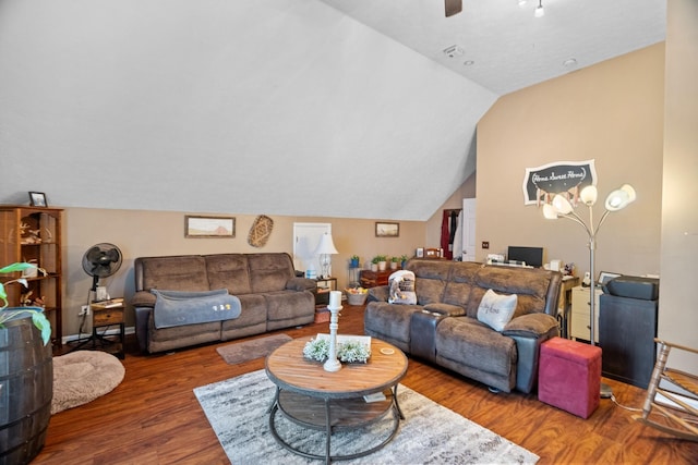 living room featuring dark hardwood / wood-style flooring, ceiling fan, and lofted ceiling