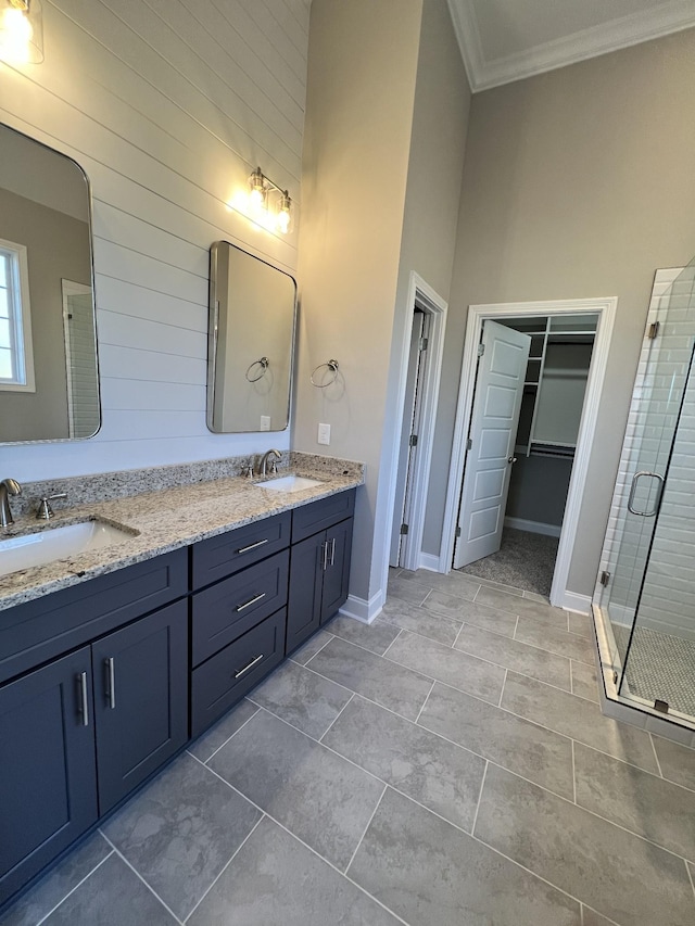 bathroom with tile patterned floors, vanity, an enclosed shower, and ornamental molding