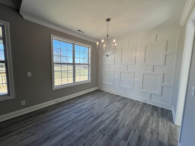 unfurnished dining area featuring dark hardwood / wood-style floors, crown molding, a healthy amount of sunlight, and a notable chandelier