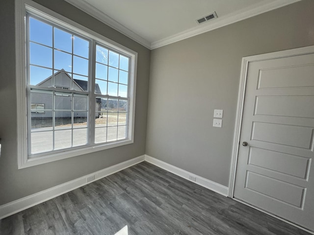 empty room featuring dark hardwood / wood-style flooring and crown molding