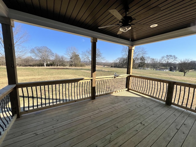 wooden deck featuring ceiling fan and a yard