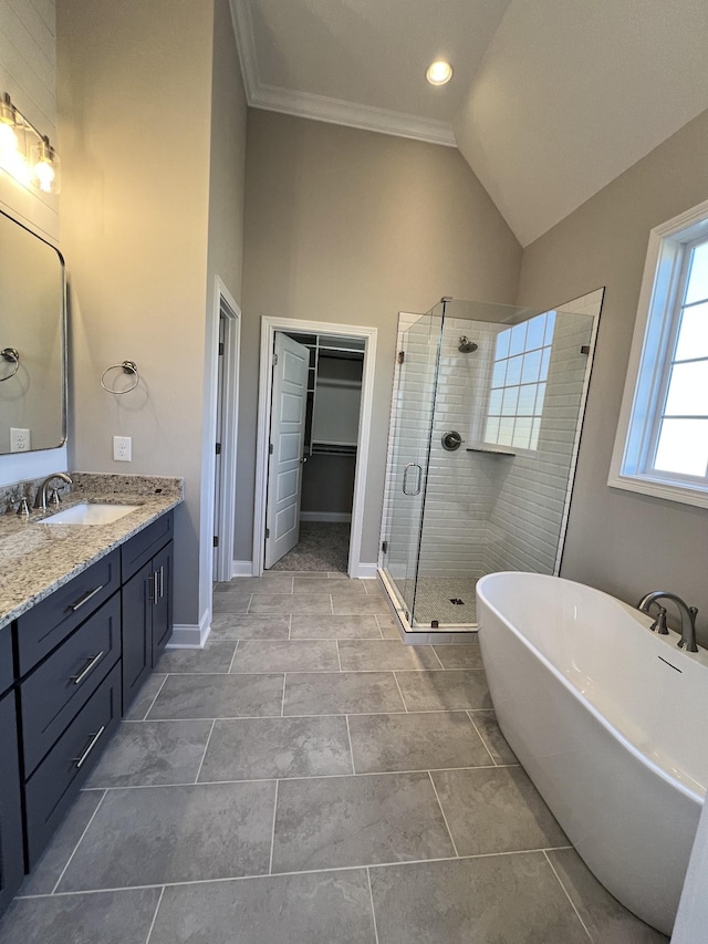 bathroom with tile patterned flooring, crown molding, lofted ceiling, shower with separate bathtub, and vanity