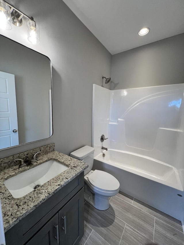 full bathroom featuring shower / tub combination, vanity, and toilet