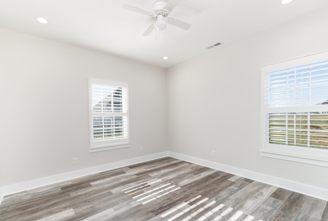 unfurnished room with ceiling fan and hardwood / wood-style flooring