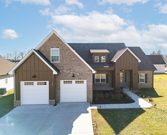 view of front of house featuring a front yard, a garage, and central AC unit