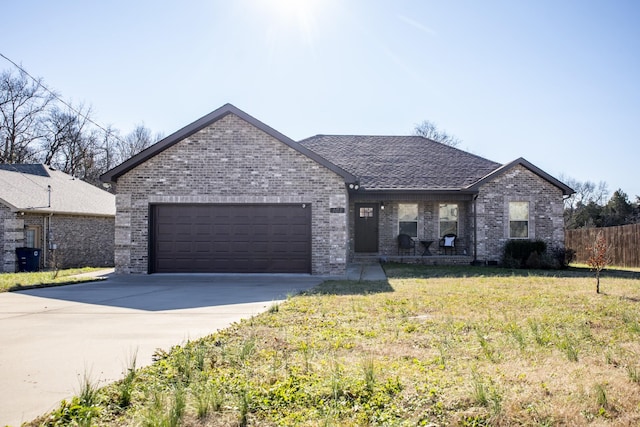 view of front of house with a front yard and a garage