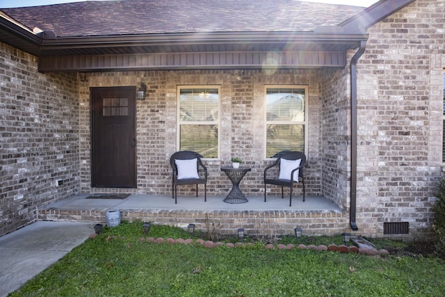 view of exterior entry featuring covered porch