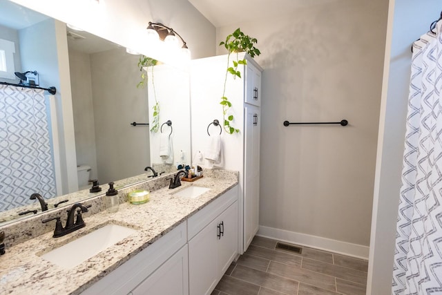 bathroom with vanity and toilet