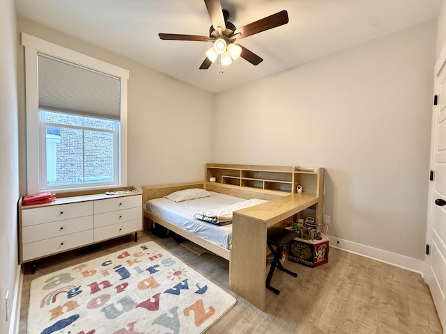 bedroom with ceiling fan and light hardwood / wood-style floors