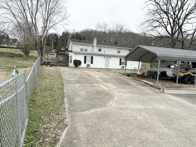 back of house featuring a carport