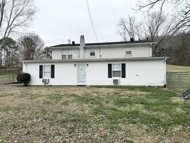 rear view of house with a lawn
