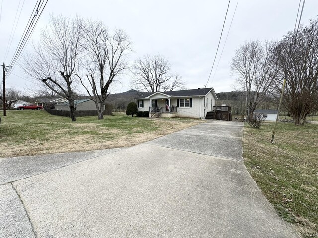 view of front of house with a porch and a front yard