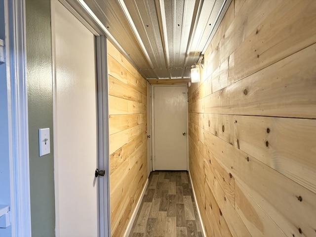 hall featuring hardwood / wood-style flooring, wood ceiling, and wooden walls