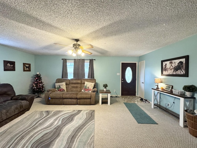 carpeted living room with ceiling fan and a textured ceiling