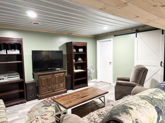 living room featuring a barn door, wood ceiling, and light hardwood / wood-style flooring