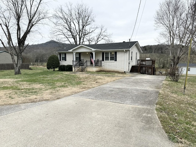 single story home featuring a mountain view and a front lawn