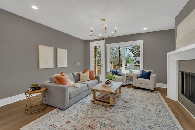 living room featuring a chandelier and light wood-type flooring